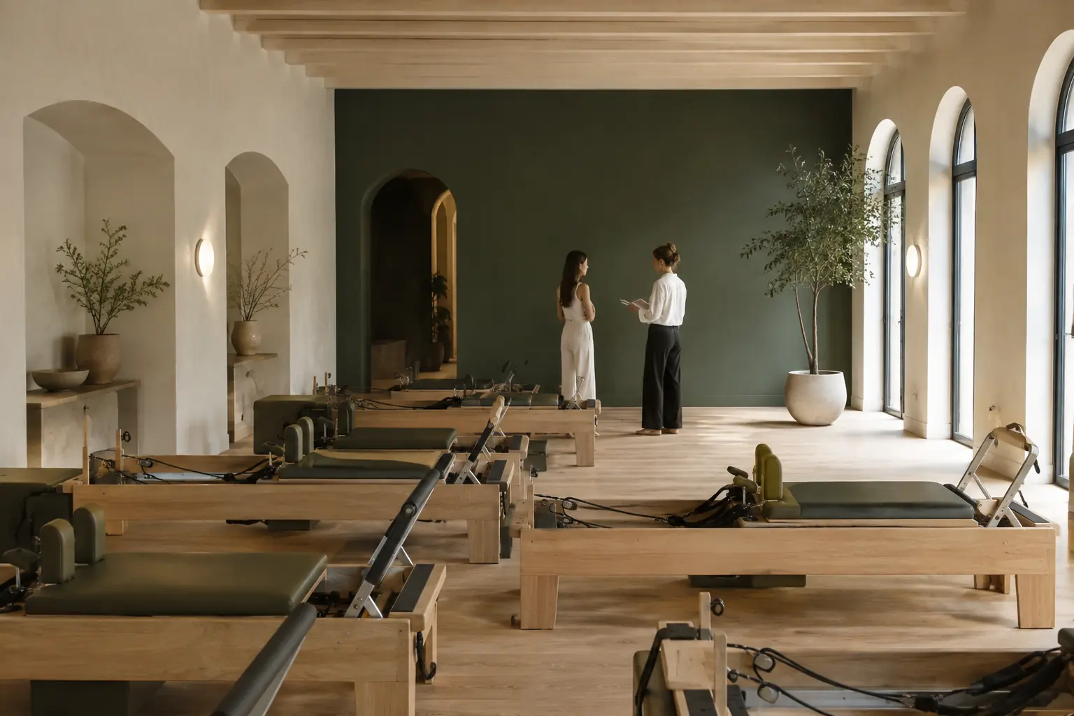 Studio owner and consultant planning a refined Pilates studio